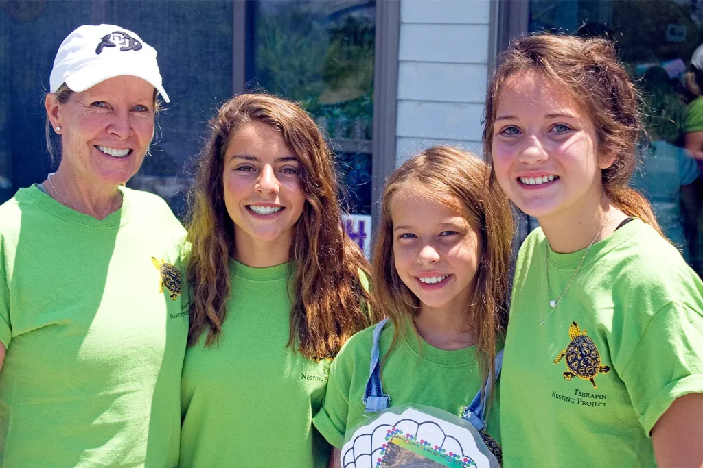 Four smiling participants wearing bright green “Terrapin Nesting Project” shirts pose together during Barnegat Bay Day at LBIF.