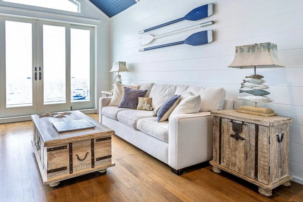 Coastal living room with neutral sofa, nautical decor, and waterfront view, featured in the 2025 LBIF Annual Seashore House Tour.