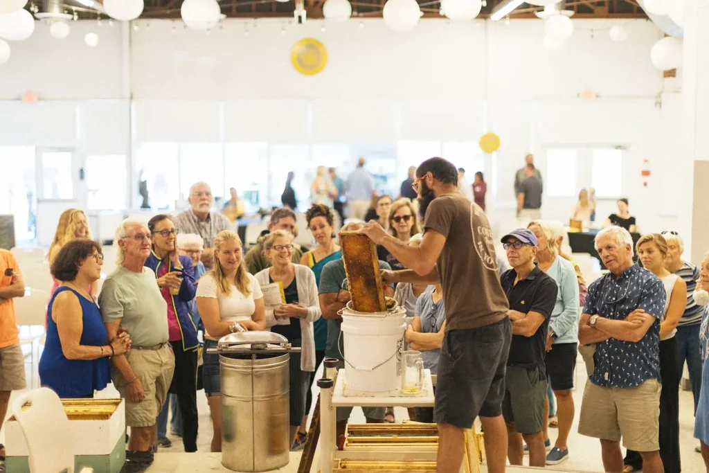 A beekeeper gives a live honey extraction demonstration to a crowd at the Long Beach Island Foundation of the Arts and Sciences.