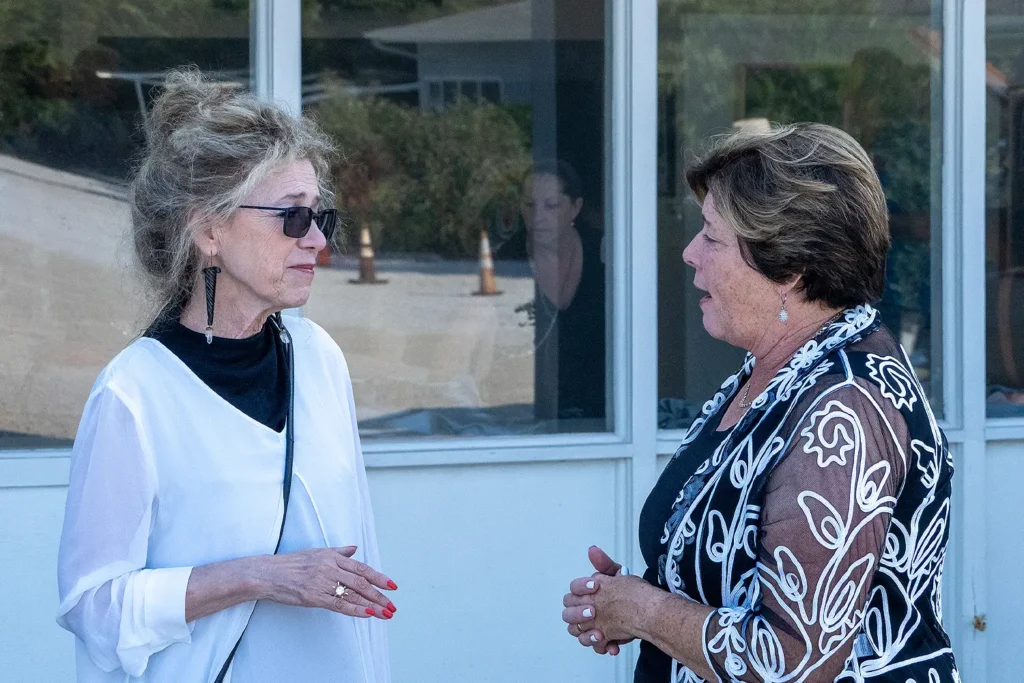Two women dressed in elegant evening attire engage in conversation outside the Long Beach Island Foundation of the Arts and Sciences during the Beach Ball Birthday Bash.