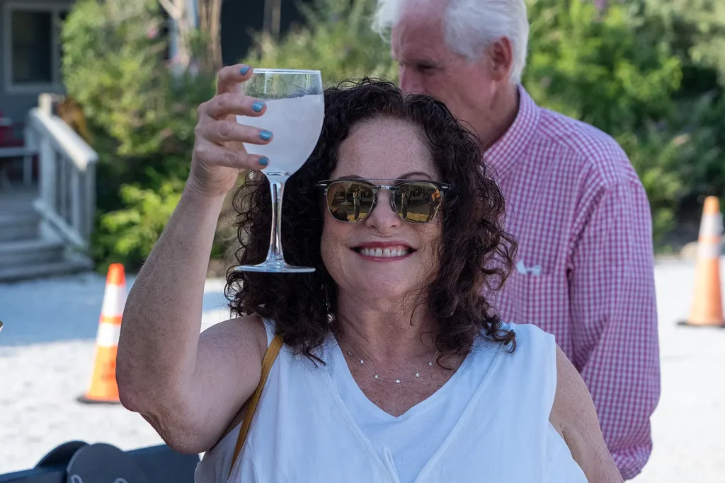 A smiling guest raises a glass in celebration during the 77th Annual Beach Ball Birthday Bash at the Long Beach Island Foundation of the Arts and Sciences.