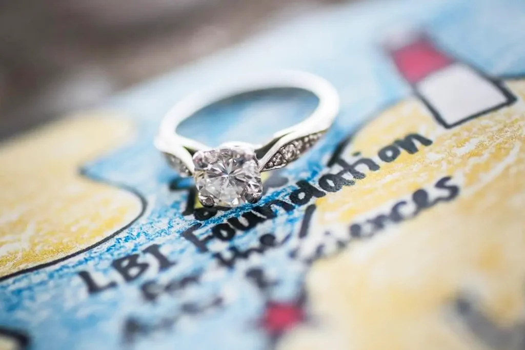 Diamond engagement ring resting on a map of Long Beach Island.